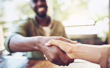 Two people shaking hands; find a lender today, get a business or commercial loan